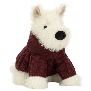 The Jellycat Munro Scottie Dog Winter Jumper Outfit is a plush white Scottie dog, sitting upright in a maroon jumper, facing slightly left.
