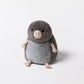 The Muswell Mole by Jellycat is a round, plush toy with a grey body, light grey belly, beige arms, feet, and nose, plus black stitched eyes—ready to join your adventures as it sits on a plain white background.