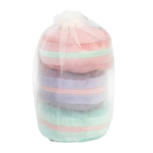 A clear gift bag containing neatly stacked, soft Le Macarons towels from Mon Ami in shades of pink, purple, and mint green—perfect for a vibrant tea party setting.