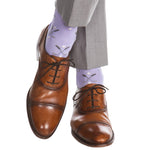 Steel gray and white mid-calf socks from Dapper Classics, designed with a golf club and ball pattern, paired perfectly with brown leather dress shoes and gray pants for added sophistication.