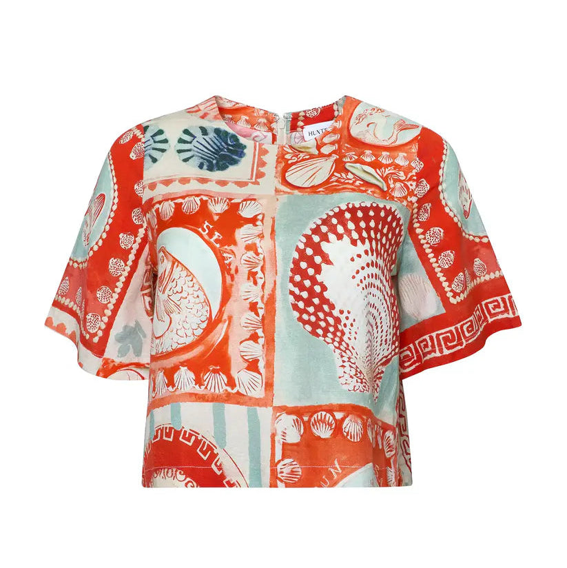 The Maeve Top by Hunter Bell NYC features short sleeves, a boxy silhouette, and a vibrant Lost at Sea print with red, orange, and teal seashells and fish.