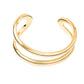 The Lie Studio Maggie Bracelet features a minimalist double band gold design, styled on a white background. This elegant cuff adds versatile sophistication to any outfit.