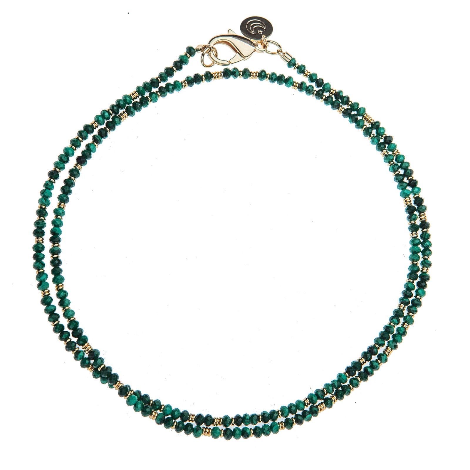 The Jane Win Double Wrap Beaded Necklace features two strands of small, faceted green and gold beads with a gold clasp, artfully arranged in a circular shape on a white background.