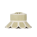 The Lorna Murray Manhattan Hat is a beige and white woven sun hat with a wide, flared brim featuring scalloped edges and UPF 50+ protection, perfect as a stylish travel accessory, displayed against a plain white background.