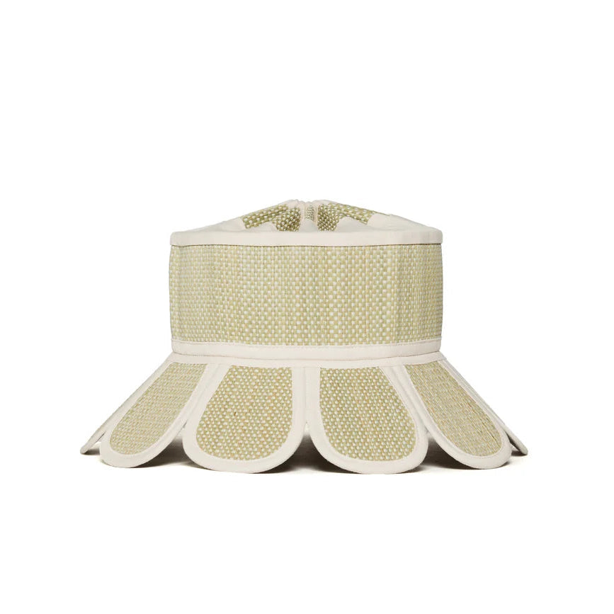 The Lorna Murray Manhattan Hat is a beige and white woven sun hat with a wide, flared brim featuring scalloped edges and UPF 50+ protection, perfect as a stylish travel accessory, displayed against a plain white background.