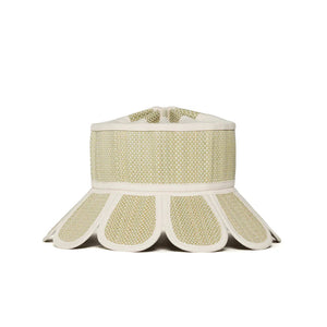 The Lorna Murray Manhattan Hat is a beige and white woven sun hat with a wide, flared brim featuring scalloped edges and UPF 50+ protection, perfect as a stylish travel accessory, displayed against a plain white background.