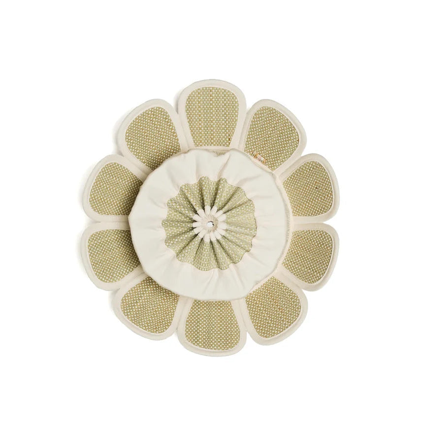 The Manhattan Hat by Lorna Murray is a round, flower-inspired cushion featuring textured, petal-like segments and a central fabric circle in beige and light green shades reminiscent of classic sun hats, shown against a plain white background.