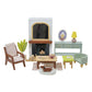 The Tender Leaf Mulberry Mansion by Tender Leaf Toys boasts a modern living room set that includes a miniature fireplace, chair, coffee table, side table, lamp, and a small decorative dog.