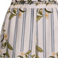 Close-up of the Tota Pant by Agua By Agua Bendita: linen high-rise pants with vertical blue stripes and a green floral pattern on white, featuring an elastic waistband with gathered detail.