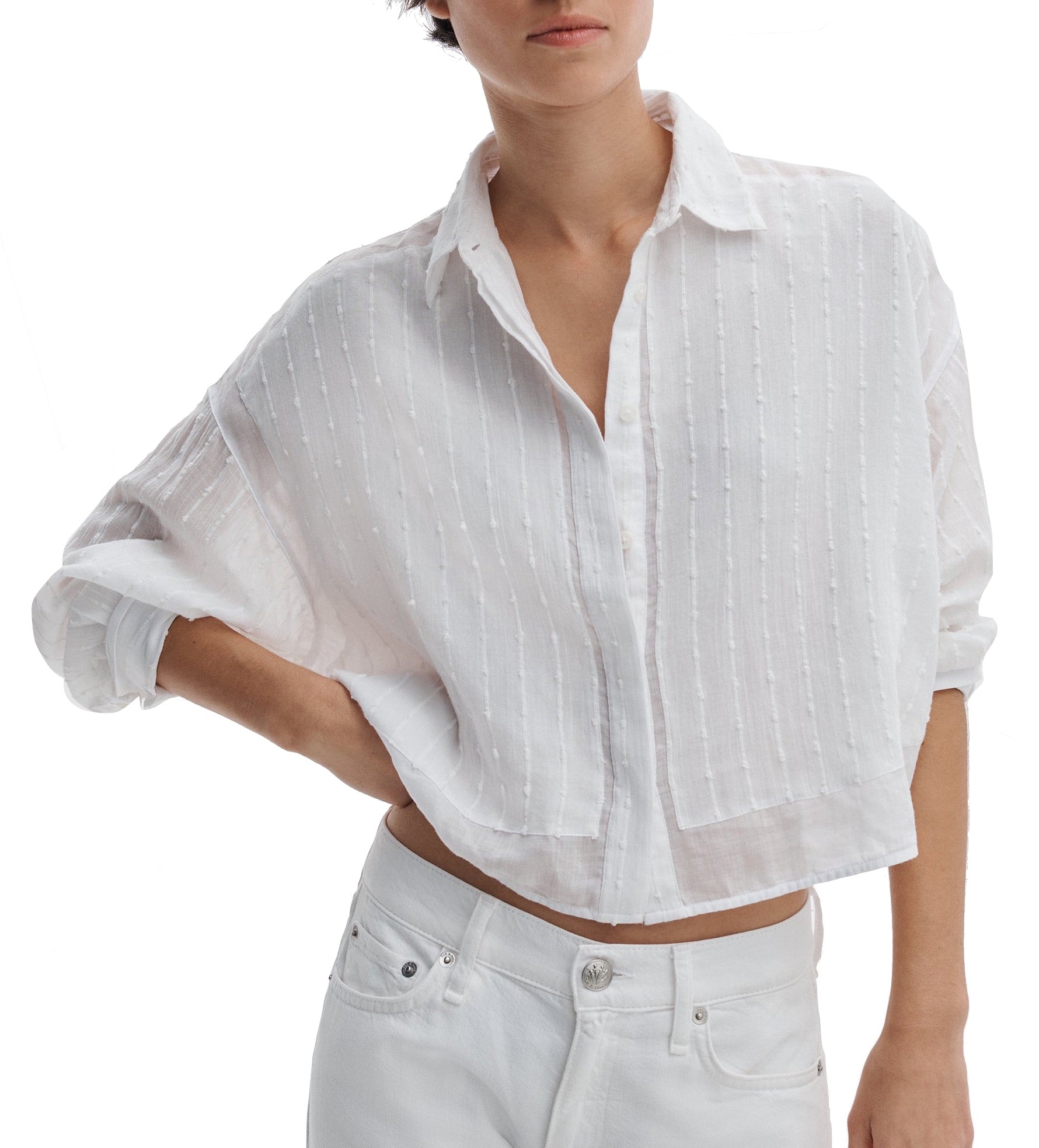A person wears the Rag & Bone Marin Combo Shirt—a loose, white, long-sleeve embroidered cotton top with subtle stripes—paired with white pants for a relaxed silhouette.