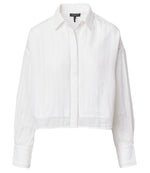 The Marin Combo Shirt by Rag & Bone is a white, long-sleeve cropped button-up with subtle vertical stripes, a relaxed fit, and a front button placket.
