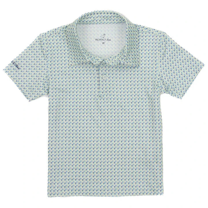 The Boys' Inlet Polo by Properly Tied is a short-sleeve, buttonless polo made from moisture-wicking fabric with a blue and white geometric pattern, spread collar, and a small logo near the shoulder on a white background.