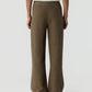 A person is shown from the back against a plain background, wearing the Guest in Residence Marquise Pant—high-waisted, wide-leg trousers featuring a brown and black geometric diamond pattern and a comfortable drawstring waist.