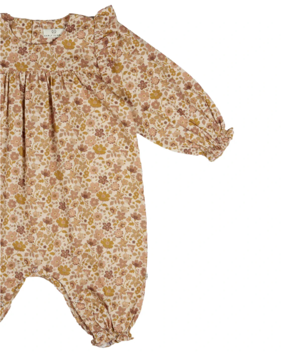 The Early Sunday Baby Martha Overalls Romper, featuring a garden flower print with long sleeves and ruffled cuffs, adds an adorable charm against a plain background.