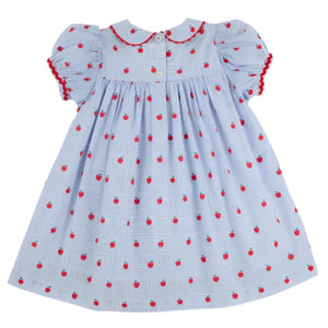 The Beaufort Bonnet Company’s Girls' Mary Dal Dress in light blue features short sleeves, a Peter Pan collar, red rickrack trim, and an all-over small red apple print—a sweet “Apple of My Eye” look.