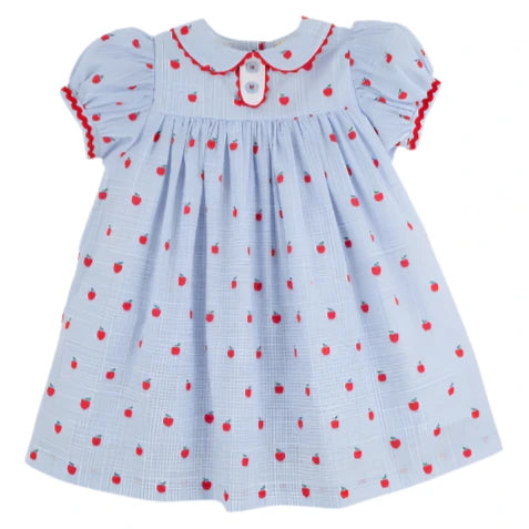 The Beaufort Bonnet Company's Girls' Mary Dal Dress features a light blue color, puffed sleeves, red apple patterns, red trim, and a white button on the collar—perfect for your little "Apple of My Eye.