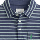 The Johnnie-O Matthis Polo, made from the brand's original fabric, showcases classic blue and white stripes with a buttoned design and a small green embroidered logo on the pocket for ultimate comfort and style.