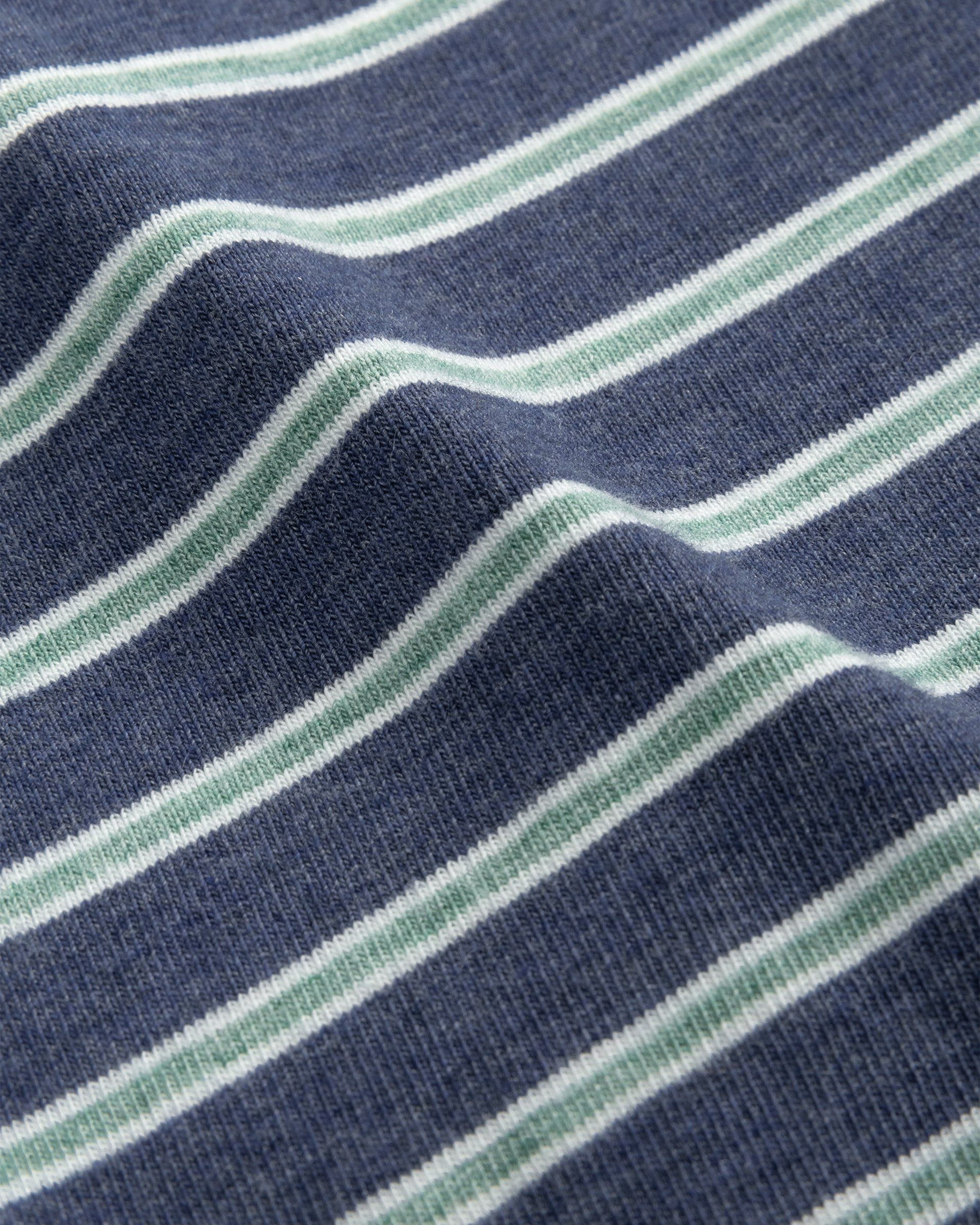 A close-up of an original fabric with horizontal navy blue and white stripes mirrors the slightly wavy texture of a Johnnie-O Matthis Polo.