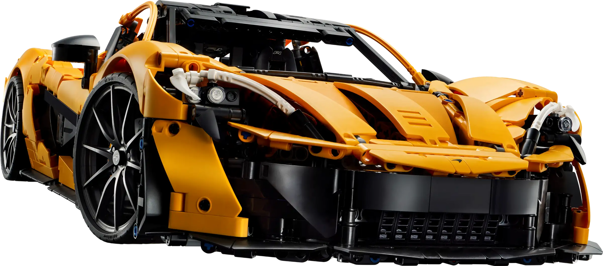 Discover the LEGO® Technic™ McLaren P1™ Hypercar from Legos - Toyhouse, a 1:8 scale model in orange with black accents. Photographed from a low angle, it embodies speed and precision with intricate design details.