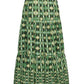 The Melanie Skirt by Cara Cara features a geometric starburst pattern in light green and cream on a dark background. This effortless green skirt showcases a flattering tiered silhouette with an elastic waist, offering comfortable, everyday style.