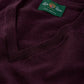 Close-up of a folded dark purple Millbreck V-Neck Merino Wool Sweater with a green label that reads “Alan Paine, Pure Merino.” This classic men’s layering piece by Alan Paine is expertly crafted from premium merino knitwear, offering unparalleled comfort and timeless style.