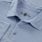 Close-up of the Tutbury Faded Dye Jersey Polo in light blue, featuring three buttons and “Alan Paine” branding on the inner collar, designed with a flexible fit for comfort—making it an ideal casual summer shirt.