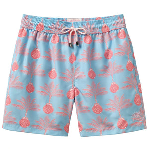 Pink House Mustique Swim Trunk: Light blue swim shorts with pink palm tree and pineapple print, made from recycled plastic. Features elastic waistband, white drawstring, quick-dry fabric, and mid-thigh length.