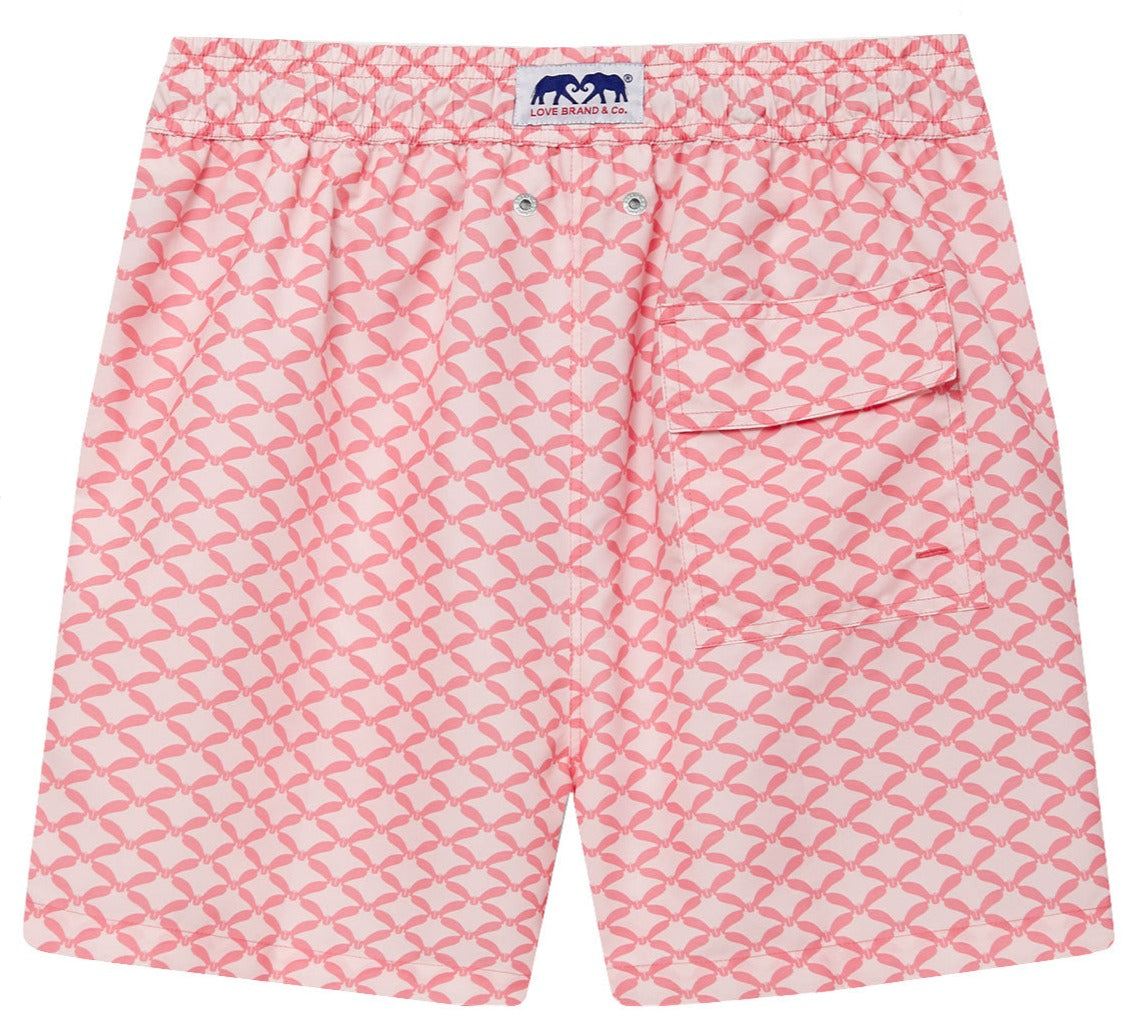 Love Brand & Co. Ray Rhythm Staniel Swim Trunk with a whimsical whale pattern, crafted from quick-dry recycled fabrics. These swim trunks feature an elastic waistband, a back pocket with a button flap, and a logo tag at the waistband.