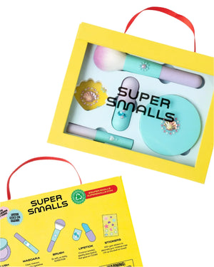 The Super Smalls Mermaid Makeup Play Kit comes in a yellow box with a brush, lipstick, compact, stickers, and red-handled mascara—everything your child needs for a mermaid beauty adventure. Illustrated instructions are included on the back.