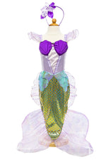 Showcase the magical sea princess vibe with the Great Pretenders Mermaid Dress & Headband on a mannequin. This child-sized ensemble, crafted by Great Pretenders, features a purple seashell top, a green scale-patterned tail made from holographic fabric, and a coordinating headband with a bow.