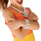 A child in a sleeveless orange and yellow kids' summer set crosses their arms while wearing the Super Smalls Supersmalls Mermaid Pool Party Mega Set, complete with a beaded necklace and bracelet.