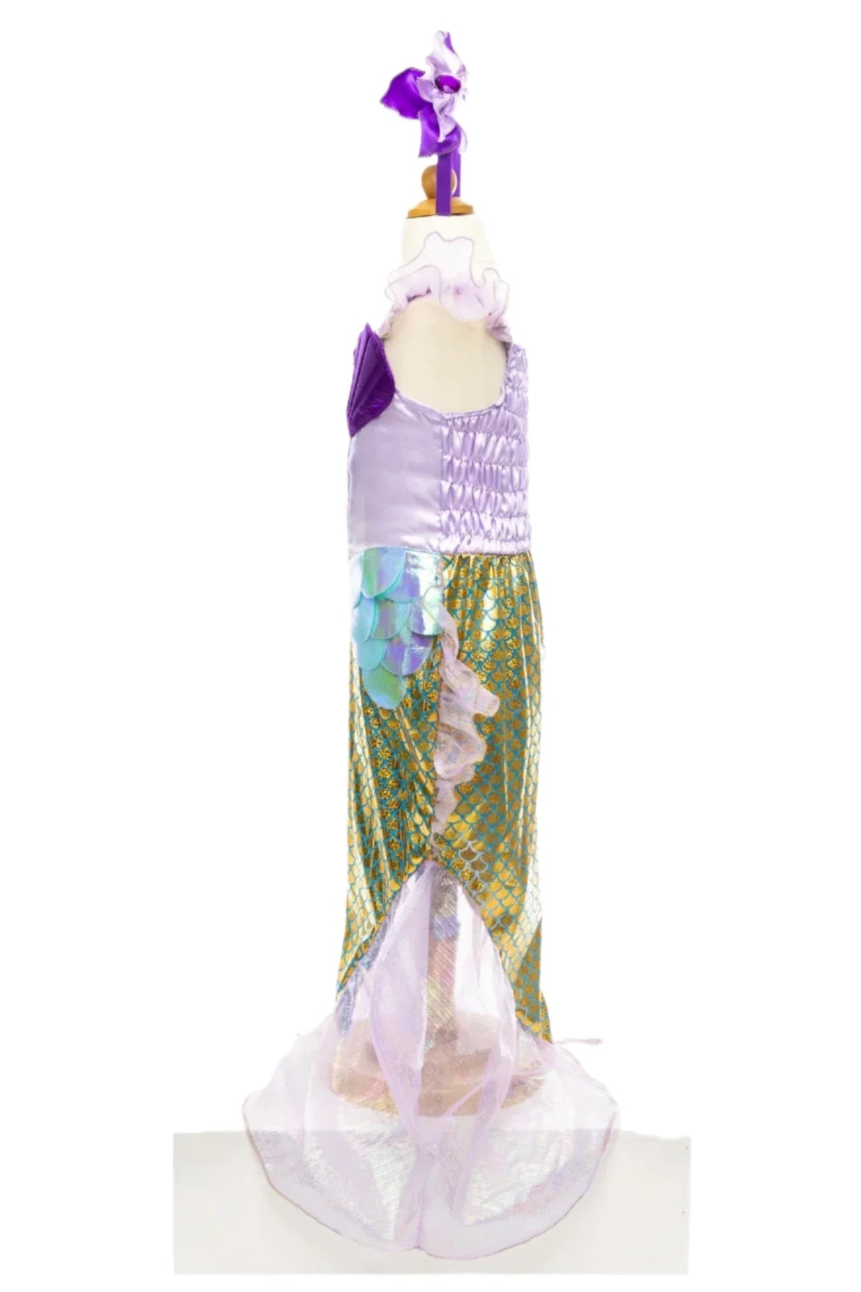 A Great Pretenders Mermaid Dress & Headband is displayed on a mannequin, featuring holographic fabric with purple, green, and gold scales, a ruffled fin, and a coordinating headband ideal for any aspiring sea princess.