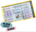 The Mermaid Press On Nail Kit by Super Smalls is a boxed set of colorful, reusable press-on nails featuring ocean-inspired designs and convenient pre-applied adhesive.