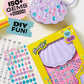 The Super Smalls Mermaid Gemify Purse kit includes a purple shell-shaped kids bag, over 150 colorful gem stickers for decorating, and comes with packaging that displays gem sheets and easy instructions.