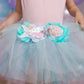 A child was wearing a light pink top and the Great Pretenders Mermalicious Tutu, a light blue tulle skirt from the Great Pretenders brand that features a decorative waistband with mermaid embellishments like sequin fish and shells.