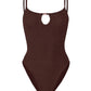 The Mia Beaded Swim by Hunza G is a brown one-piece featuring the brand’s signature crinkle fabric, slim shoulder straps, and a small keyhole cutout at the neckline.