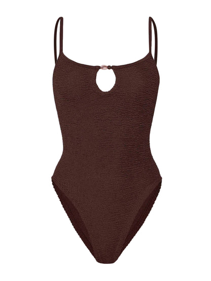 The Mia Beaded Swim by Hunza G is a brown one-piece featuring the brand’s signature crinkle fabric, slim shoulder straps, and a small keyhole cutout at the neckline.