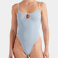 A woman wearing the Hunza G Mia Beaded Swim, a light blue crinkle fabric swimsuit with thin straps, a small front keyhole cutout, and a supportive fit designed to adapt to one size.