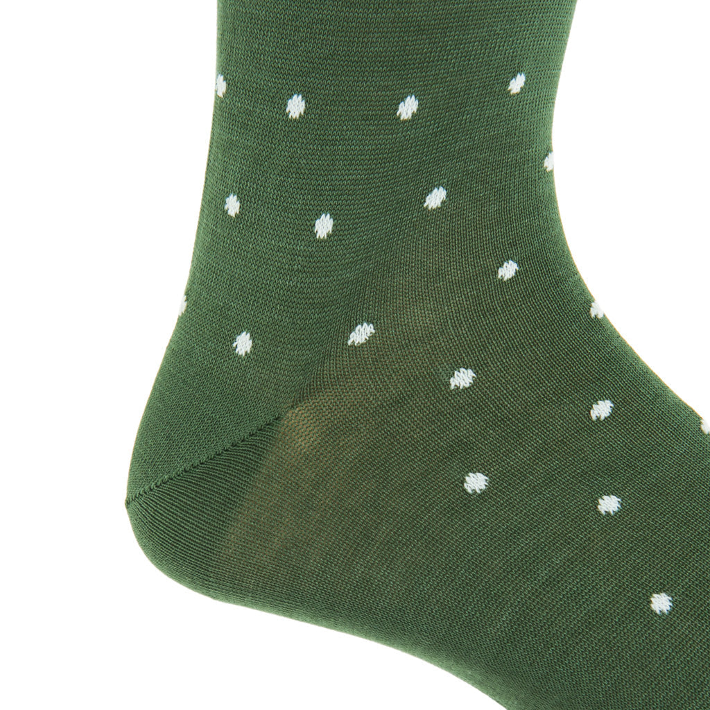 A detailed view of the Dapper Classics Dot Mid Calf Socks in Forest Green with Cream Dot, highlighting the heel and part of the foot. Made from mercerized cotton, these socks by Dapper Classics provide an elegant addition to your wardrobe staples.