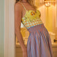 A woman stands indoors wearing the Gasparilla Gardens One Piece by Hunter Bell NYC.