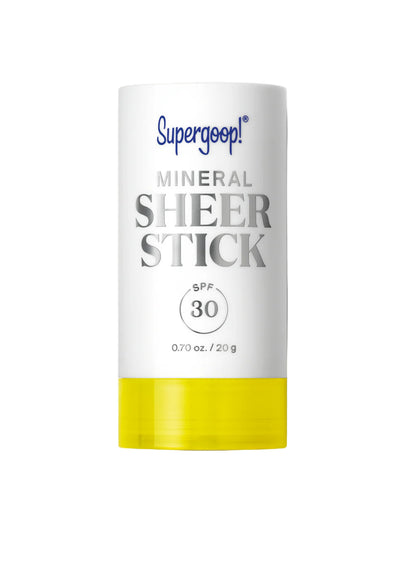 A white and yellow tube labeled "Supergoop Mineral Sheer Stick SPF 30" (0.70 oz/20 g) rests on a white background, showcasing this convenient sheer sunscreen for easy sun protection.