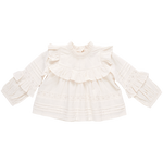 The Pink Chicken Girls' Lace Mira Top, crafted from 100% cotton cambric, is a white blouse with long sleeves, adorned with elegant ruffle details on the front and sleeves.