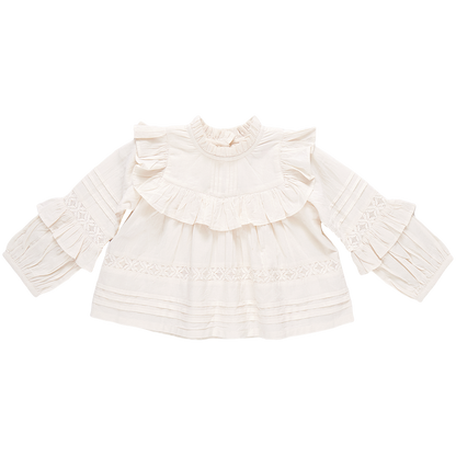 The Pink Chicken Girls' Lace Mira Top, crafted from 100% cotton cambric, is a white blouse with long sleeves, adorned with elegant ruffle details on the front and sleeves.