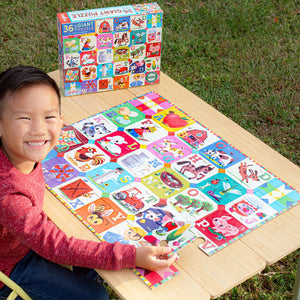 A smiling child sits at an outdoor table, assembling the colorful My Farm Alphabet 36-Piece Giant Puzzle by Eeboo, which features illustrated farm animals and objects. The puzzle box rests on the table, inviting playful learning to encourage pre-literacy skills.