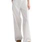 A person demonstrates a chic wide-leg silhouette in the TWP Hudson St. Cotton Stripes Pant, featuring subtle vertical stripes, paired with a dark top and brown shoes.