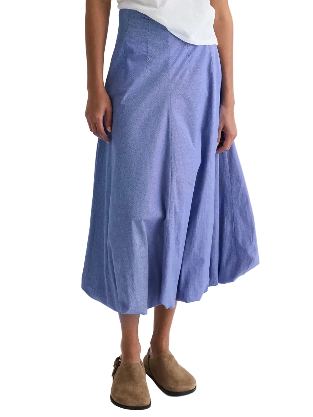 Person wearing a white shirt, TWP Full Intentions Cotton Poplin Skirt in light blue micro check, and brown suede shoes, standing against a white background.