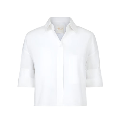 The TWP Next Ex Shirt is a white, short-sleeved, collared button-up with a chest pocket and boxy silhouette, shown against a plain background.