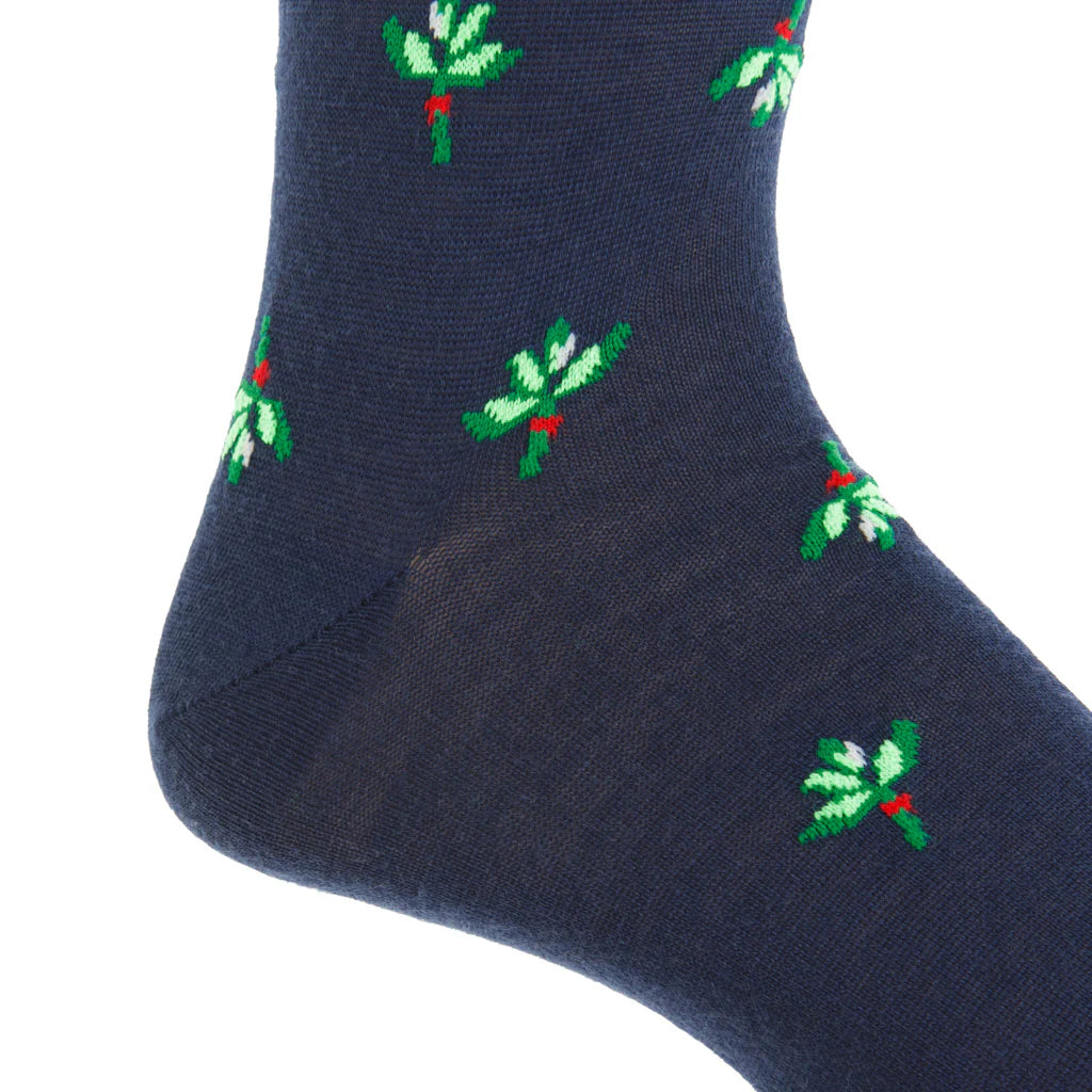 The Dapper Classics Dress Navy with Green and White Mistletoe Fine Merino Wool Sock features a mistletoe motif and a linked toe, offering breathable comfort in a stylish mid-calf design.