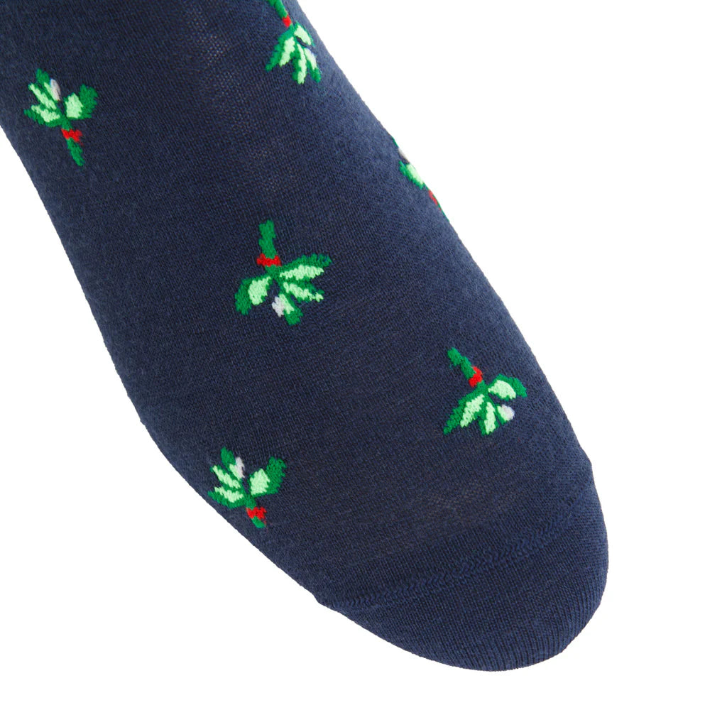 Close-up of the Dapper Classics Dress Navy with Green and White Mistletoe Fine Merino Wool Sock, a mid-calf, breathable sock featuring a small mistletoe motif and comfortable linked toe.