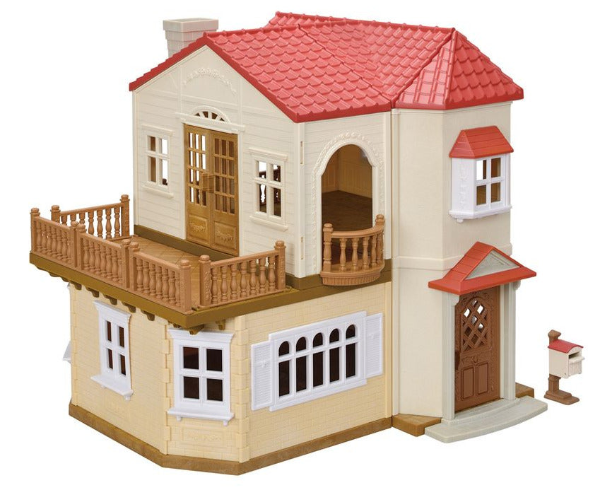 The Calico Critters Red Roof Country Home Gift Set is a plastic dollhouse playset featuring a red roof, brown balcony, white windows, and a small mailbox by the front door—perfect for recreating your favorite Sylvanian Families scenes.